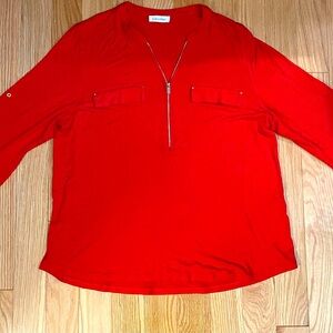 Women’s Calvin Klein, front zip red three-quarter sleeve blouse. Missing tags.